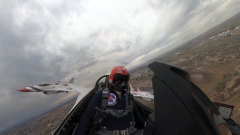CIRCA 2020 - U.S. Air Force cockpit footage of Thunderbird jet fighter plane and pilot aerial acrobat team flight, Denver Colorado.