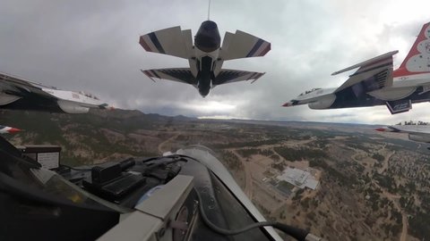CIRCA 2020 - U.S. Air Force cockpit footage of Thunderbird jet fighter plane and pilot aerial acrobat team flight, Denver CO.
