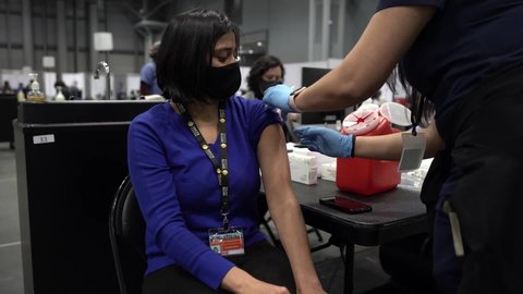 CIRCA 2020 - Officials receive COVID-19 pandemic vaccines and rehearse procedures for public health innoculations in NYC.