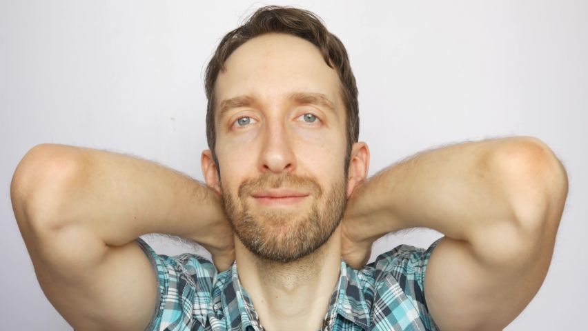 Close-up of a cute smiling man showing two yellow round signs with the word SALE