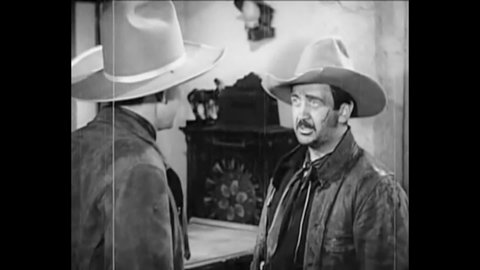 CIRCA 1937 - In this western film, a cowboy (Tex Ritter) gets into a brawl in a saloon.
