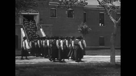 CIRCA 1919 - Native American students in Albuquerque, New Mexico march to school in uniforms.