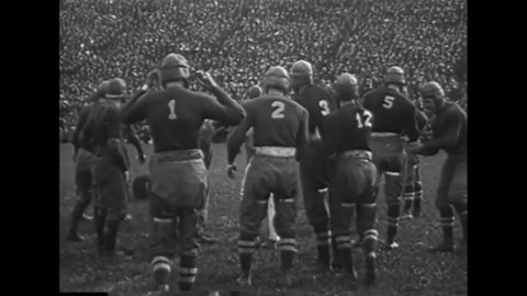 CIRCA 1918 - Knute Rockne leads the Notre Dame Fighting Irish football team.