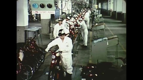 CIRCA 1963 - Bicycles are mass produced at a factory in Japan.