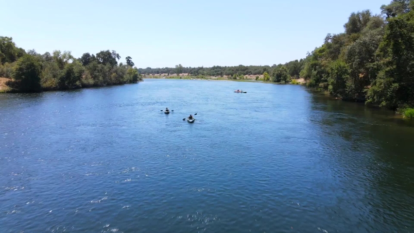 SACRAMENTO, CALIFORNIA - CIRCA 2020 - An excellent aerial shot of people kayaking on the American River in Sacramento, California. Royalty-Free Stock Footage #1071457666