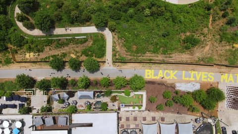 GEORGIA - CIRCA 2020 - An excellent aerial shot of people walking along a Black Lives Matter mural on the Atlanta BeltLine in Georgia.
