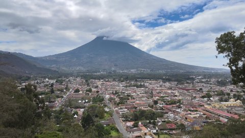 Aerial view of Antigua Guatemala. Flight from Cerro de la Cruz to the central park, with the Agua Volcano in the background.