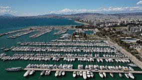 Aerial drone video of beautiful Marina of Alimos with many luxury yachts and sail boats anchored, Athens riviera, Attica, Greece