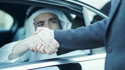 Handshake between the sheik and the businessman. Arab Sheik's limousine. Close-up of the hand. Politics, international affairs, cars
