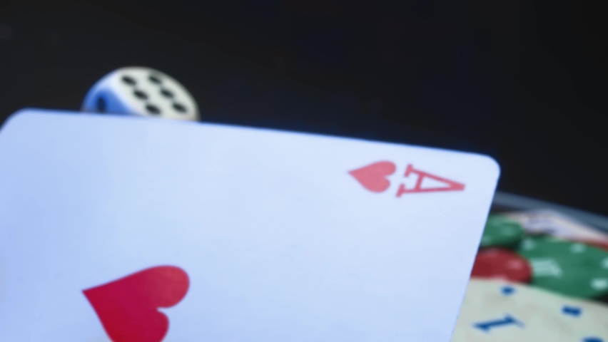 Casino chips and playing cards in motion. Concept of gambling or poker and entertainment. Close up macro shoot Royalty-Free Stock Footage #1071462892