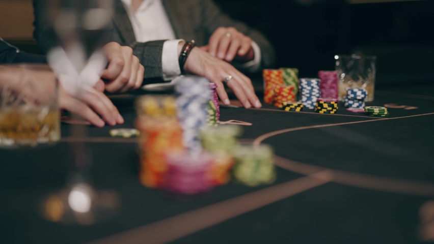 Two bearded men and young woman are looking intently at their poker playing cards make bets gambiling in a casino. Entertainment industry and luxury lifestyle. Concept of casino gambling and poker. Royalty-Free Stock Footage #1071462901