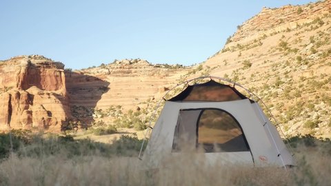 White Tent with Black Rocks Canyon in Background, Static Shot with Copy Space