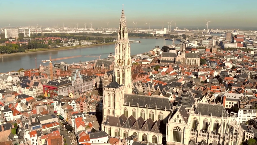 Cathedral of Our Lady amid Antwerp cityscape and Scheldt river, Belgium - Aerial wide Panoramic shot Royalty-Free Stock Footage #1071475732
