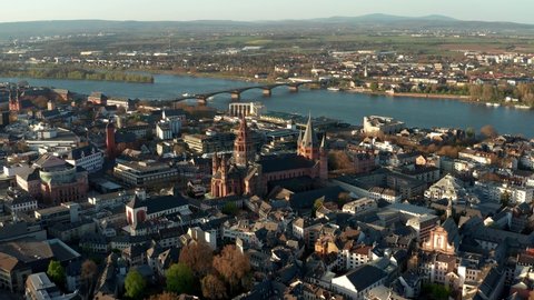 Flying closer to the Cathedral church of Mainz with drone shots on a warm spring day showing the blue river in the back