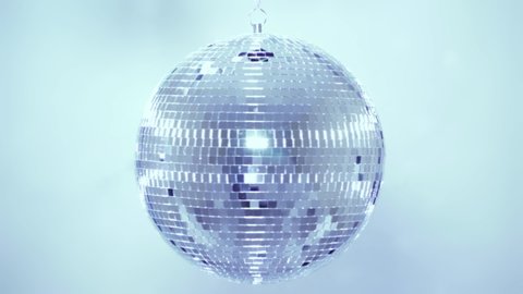 Disco ball. Mirror ball reflects white light. Disco ball with reflected moving rays.