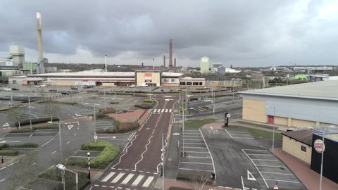 St Helens , Merseyside , United Kingdom (UK) - 04 05 2020: Aerial view deserted retail store parking areas COVID corona virus lockdown dolly left