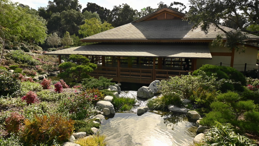 A waterfall feature in a beautiful Japanese garden in Balboa Park, San Diego - wide shot