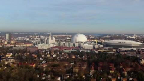 Stockholm , Sweden - 03 11 2019: Wide aerial drone shot orbiting round the Ericsson Globe and Stockholm skyline