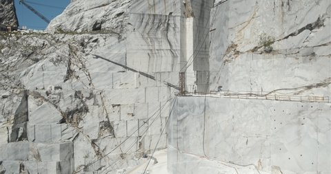 Alpi Apuane, Tuscany, Italy, about 2020. . Marble quarry.There is a derrick type crane used to lift the large weights of the marble blocks. The cuts of the marble.