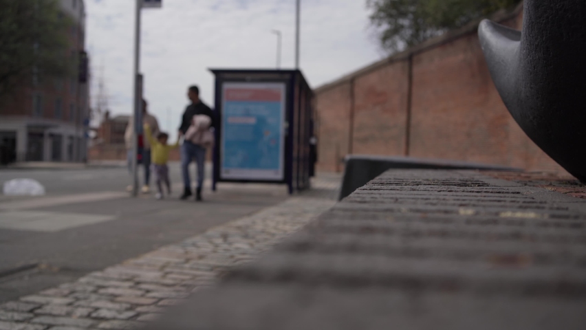 Bus stop with people walking in the background