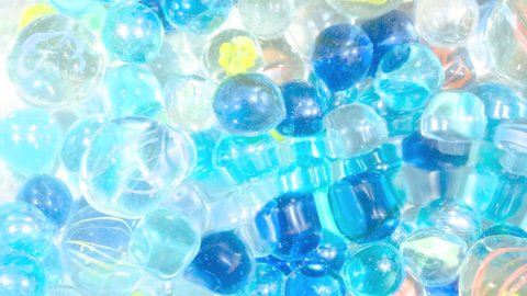 Blue and Transparent Marble Glass Balls under Waving Water, Cool Summer Image, Nobody, Fixed Shooting