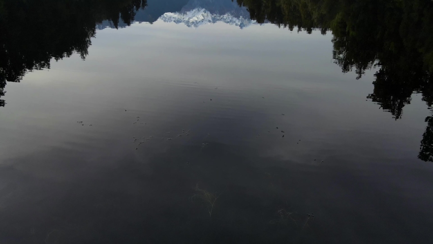 Aerial flyover Lake Metheson With Beautiful Water Reflection of Mount Cook, New Zealand.
