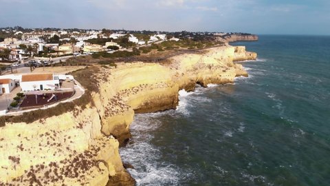 Aerial 4K drone footage of the coastline near the resort city of Carvoeiro, Portugal.