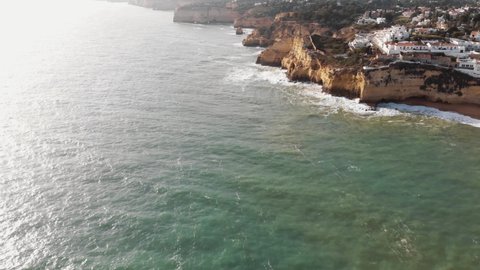 4K aerial drone footage of the rocky cliffs and coastline near the city of Carvoeiro, Portugal.