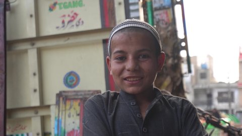 Islamabad, Pakistan - April 13, 2021: A muslim kid smiling while facing the camera. Medium shot of kid smiling face.