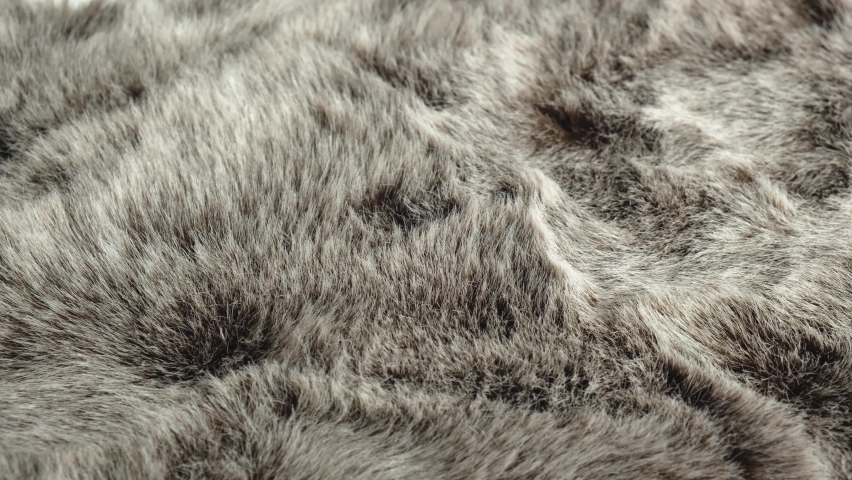 The designer checks the quality of the faux fur, touches and strokes it. Artificial fur is a textile material that imitates natural animal fur. The concept of fashion and animal welfare. | Shutterstock HD Video #1071551563