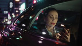 Beautiful Businesswoman is Commuting from Office in a Backseat of Her Car at Night. Entrepreneur Using Smartphone while in Transfer Taxi in Urban City Street with Working Neon Signs. - Powered by Shutterstock - Get 15% off with code: PIKWIZARD15