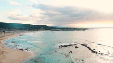Aerial top view of blue crystal blue water sea and sandy beach aerial view drone shot. Bird's eye view of Ayfilon Beach in Agios Philon, Karpaz, North Cyprus