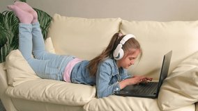 girl with headphones looking video lesson teacher conference laptop sitting