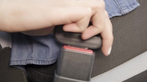 Buckle up seat belt in a car. Driver Fastening Seatbelt In Car. Woman Car Lap Buckling Inside Vehicle Before Driving. Woman Hand Fastening Car Safety Seat Belt.Protection Road Safety Snap.Close up