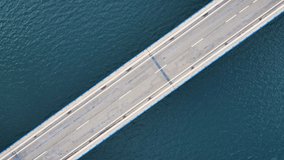 Aerial view of a bridge over sea. Creative concept of engineering or transportation. High quality 4k footage