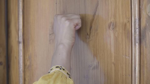 slow motion of female hand touching wooden door, door opens