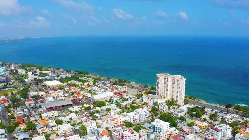 City and sea 4k stock video footage. Santo Domingo is the capital of the Dominican Republic. Beautiful city streets and roads overlooking the Caribbean Sea.