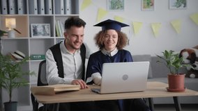 modern learning, happy young man and female student rejoice and hug each other at graduation ceremony online via laptop video link rejoicing graduation from college