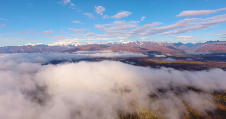 Denali and Alaska Range mountains aerial view over the cloud in fall, near Denali State Park, Alaska AK, USA.