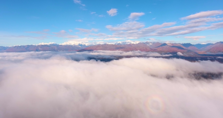 Denali and Alaska Range mountains aerial view over the cloud in fall, near Denali State Park, Alaska AK, USA.