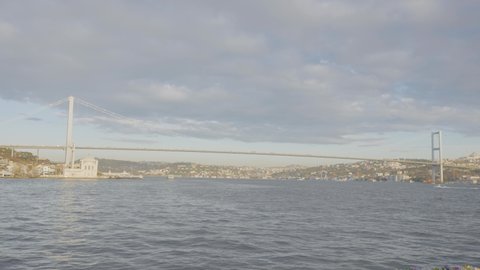 Hanging bridge over Bosphorus Strait on background of coast of Istanbul. 
