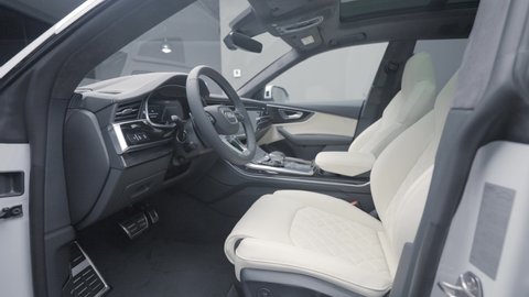 Germany, Berlin - April 2021: Expensive interior of new model car. Action. New luxury car from Audi in showroom. New car interior with white seats