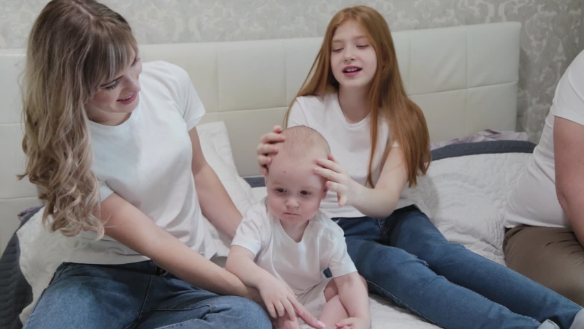 Cheerful happy family on the bed.