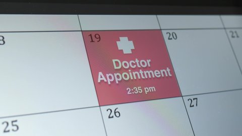 Doctor Appointment written on a digital calendar on a touchscreen tablet screen. closeup shot.