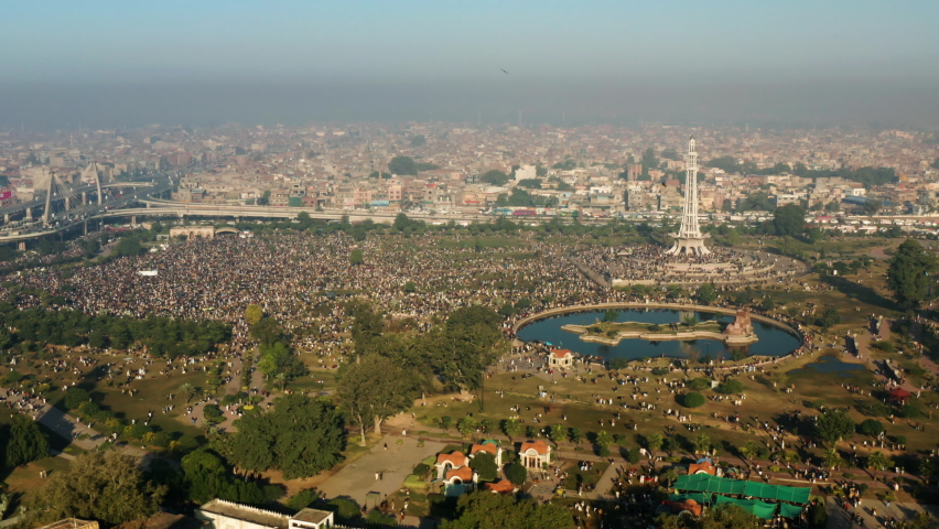 Thousands Of People Gather At Greater Iqbal Park With Minar-e-Pakistan Monument In Lahore, Punjab, Pakistan. - aerial