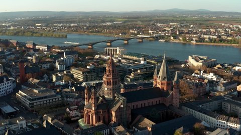 Leaving Mainz Cathedral church aerial drone shots on a warm spring day showing the blue river in the back