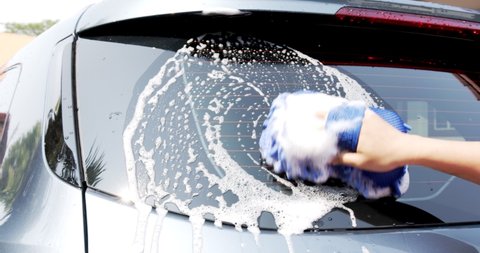 Close up women hand Washing car with soap and water Front view, Concept Car Service, Car Wash.