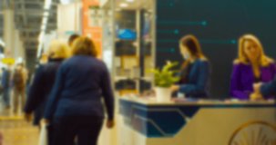 meeting of business people behind the counter in the large hall.blurry defocused video.business background.