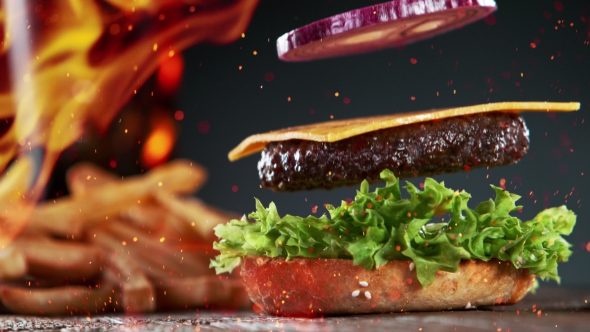 Beef Burger Ingredients Falling and Landing in the Bun | Shutterstock HD Video #1071625735