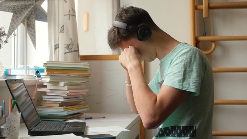 Tired student rubs eyes at computer working remotely. Bad posture can cause fatigue burnout syndrome, overwhelming workload study process. Lack of motivation 
difficulty concentrating people lifestyle Royalty-Free Stock Footage #1071636238